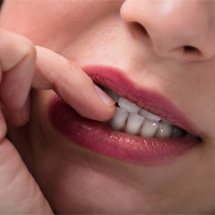 woman biting her fingernails  